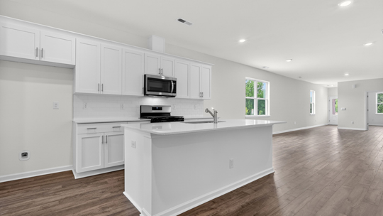 kitchen with white cabinets island and quartz countertops