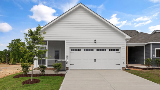 back of home with two car garage