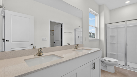 bathroom with quartz countertops and walkin shower