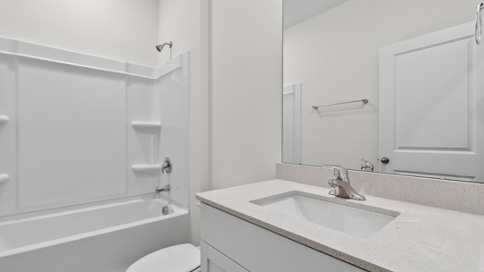 bathroom with tub shower combo and quartz countertops