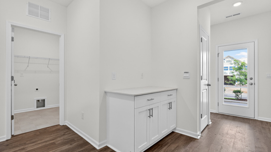 primary bathroom with walk in shower and dual vanity sinks