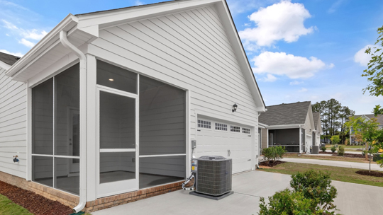 exterior enclosed patio with driveway & garage