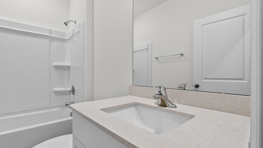 bathroom with quartz countertops and tub shower combo