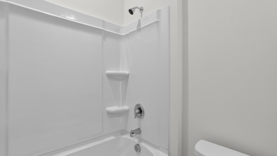 bathroom with quartz count and tub shower combo