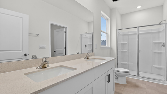 bathroom with quartz countertops dual vanity and walkin glass door shower