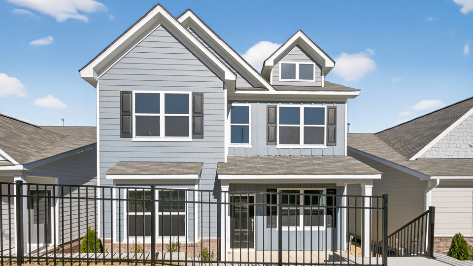 Two story home with blue colored siding and front porch