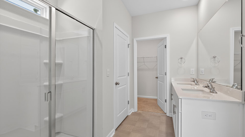 Primary bathroom with double sink and walk-in shower