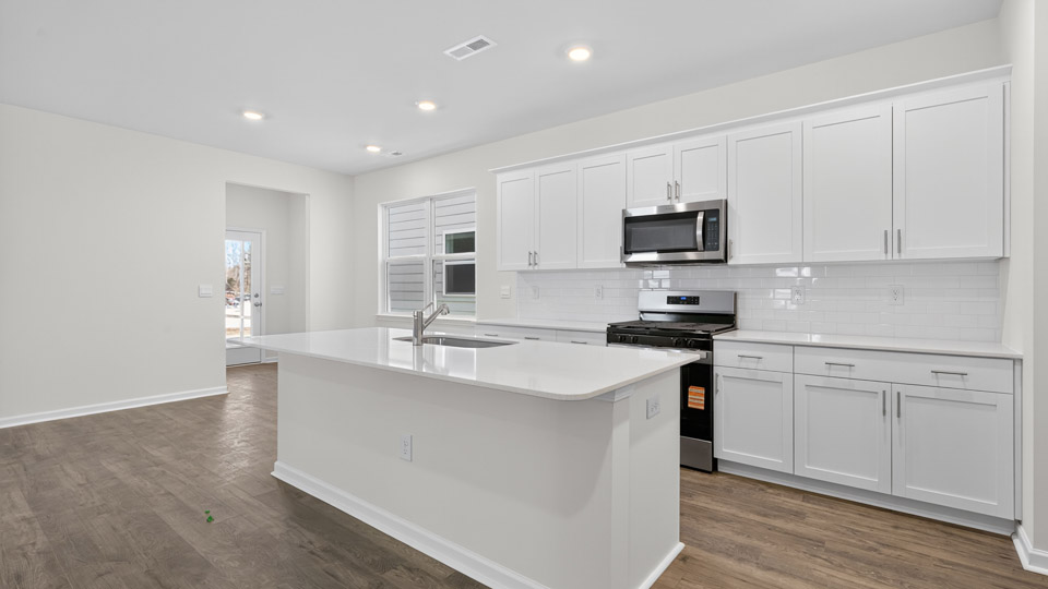 Kitchen with white cabinets and stainless steel appliances.