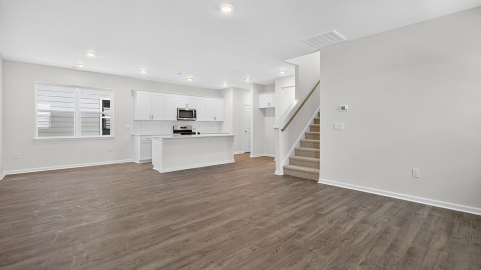 Open-concept living room leading to kitchen