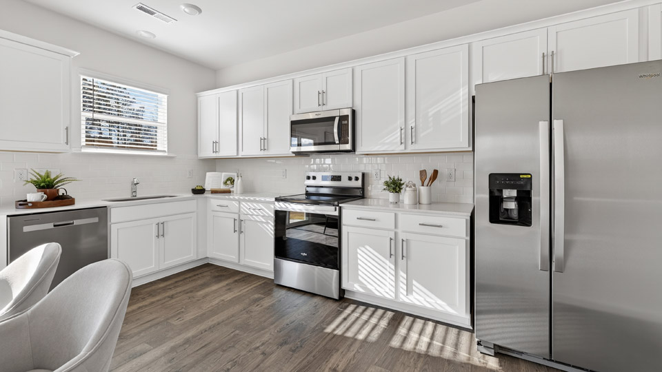 Kitchen with white cabinets and stainless steel appliances.