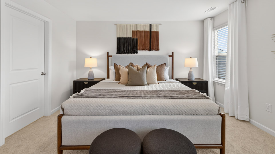 Primary bedroom with carpet floors and windows