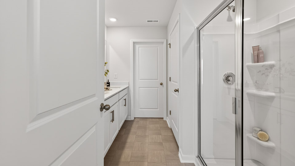 Primary bathroom with double sink and walk-in shower
