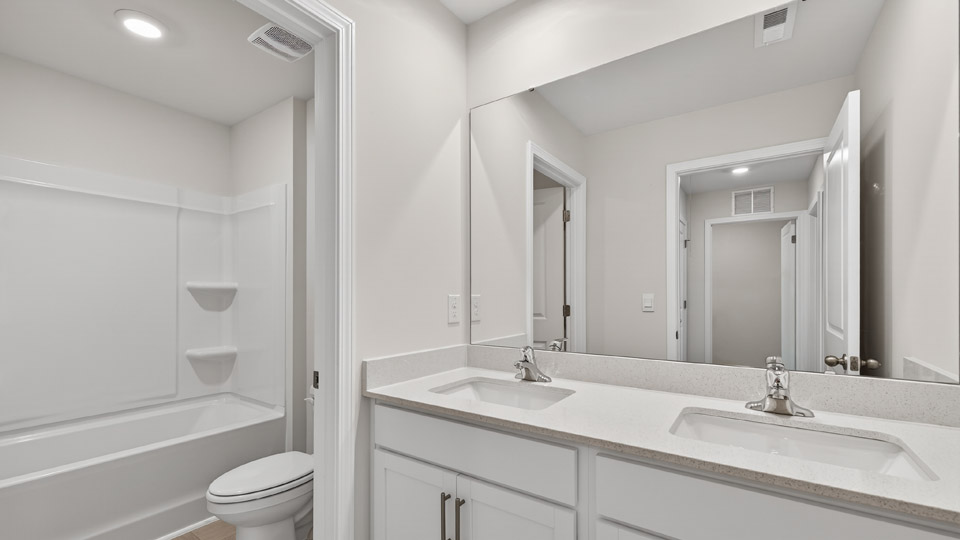 Bathroom with double sink and tub