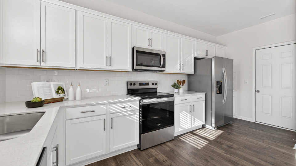 Kitchen with white cabinets and stainless steel appliances.