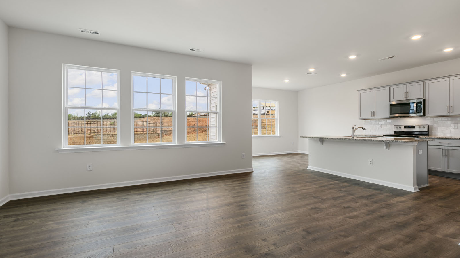 LIVING ROOM, KITCHEN, AND BREAKFAST AREA