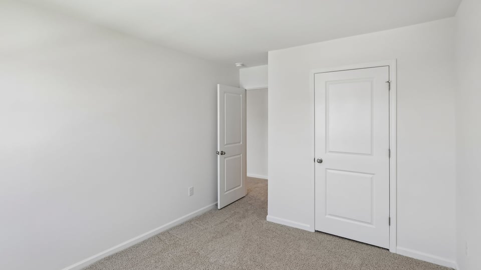 additional bedroom with window, carpeting, closet