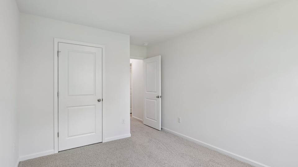 additional bedroom with window, carpeting, closet