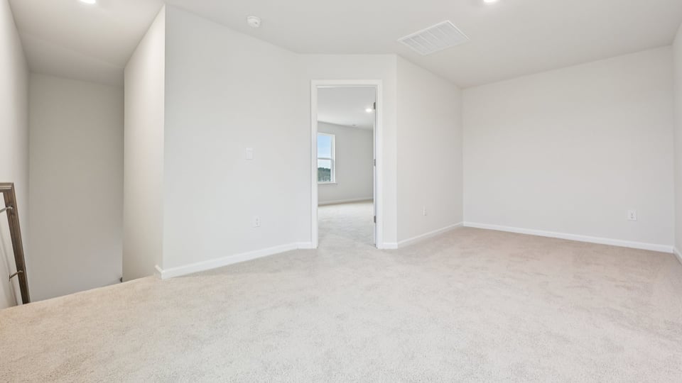 upstairs loft with carpet flooring