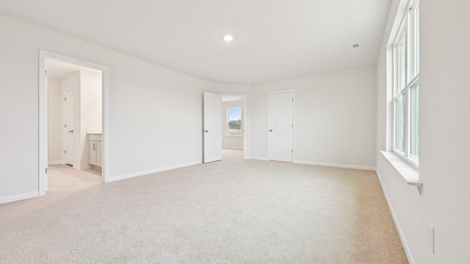primary bedroom with carpet flooring