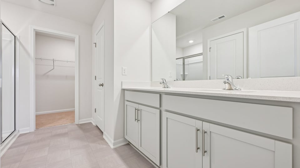 bathroom with quartz countertops and dual vanity