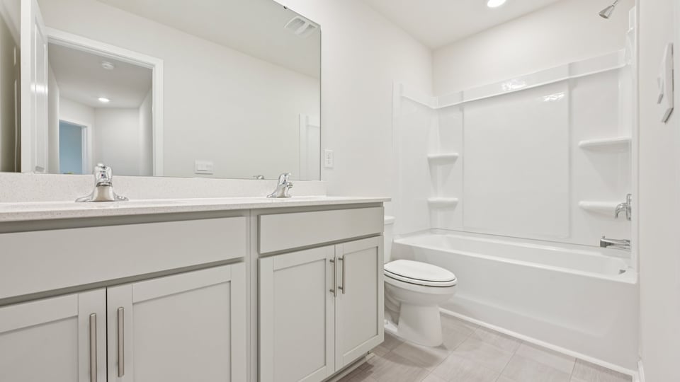 bathroom with quartz countertops and tub shower combo