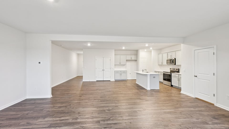 kitchen with quartz counters, kitchen island, pantry, stainless steel appliances