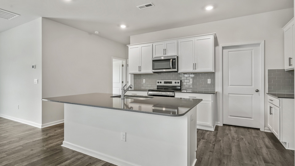 kitchen with island white cabinets and quartz countertops