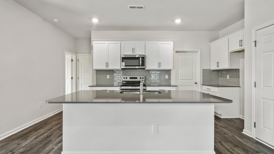 kitchen with island white cabinets and quartz countertops