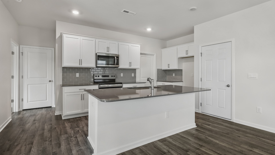 kitchen with island white cabinets and quartz countertops