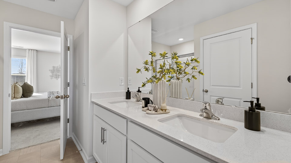 bathroom with quartz countertops and white cabinets