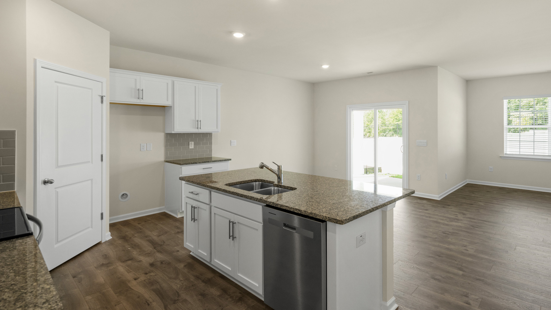 kitchen with quartz counters, kitchen island, pantry, stainless steel appliances