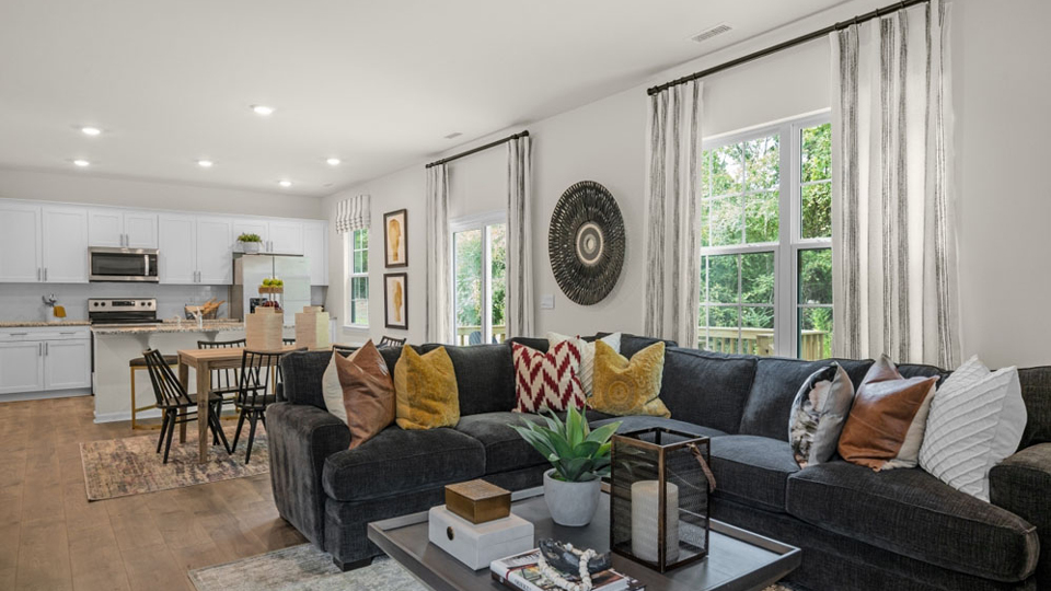 open concept living room overlooked by kitchen