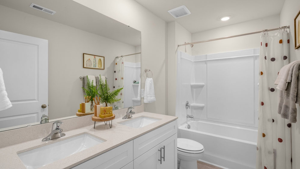 bathroom with quartz countertops and sub shower combo