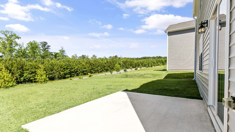 exterior patio with concrete slab and open yard