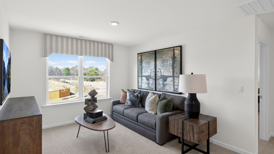 upstairs loft area with large windows and carpeting