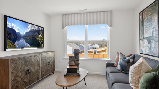 upstairs loft area with large windows and carpeting