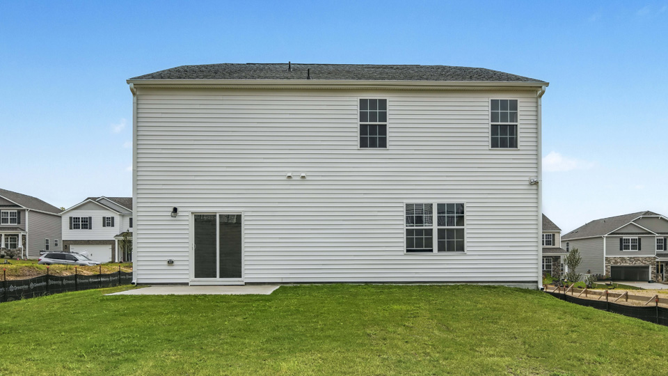back exterior of wilmington A with concrete patio and open yard