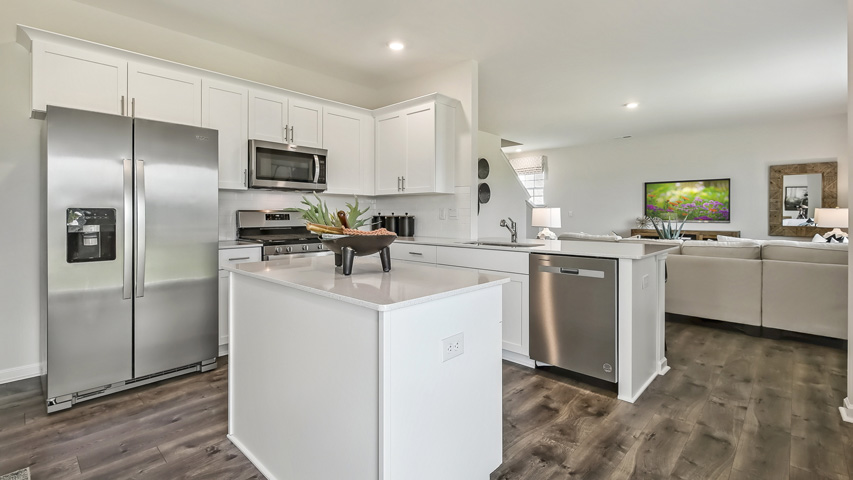 kitchen with white cabinets quartz countertops and island