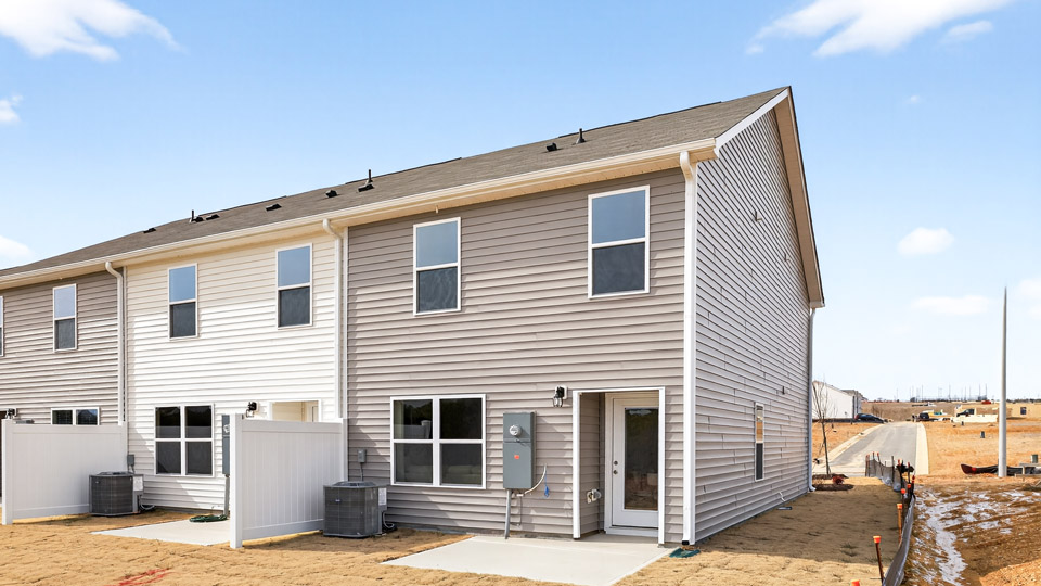 Two story town home with brown siding.
