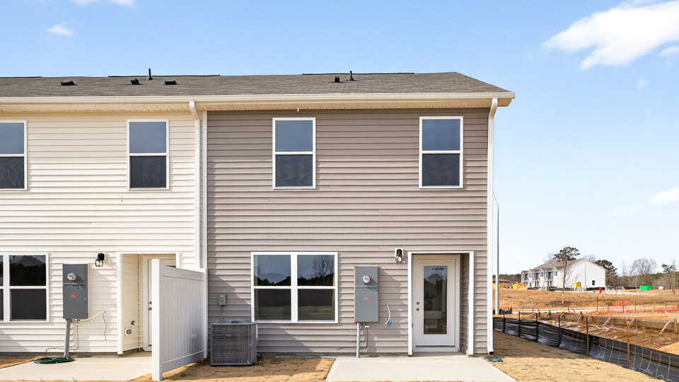 Two story town home with brown siding.