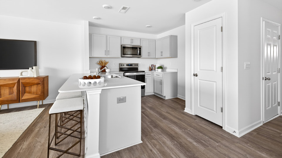 Kitchen with gray cabinets and stainless steel appliances.