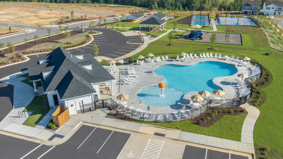 aerial shot of community pool clubhouse and playground