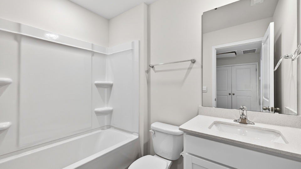 secondary bathroom with shower tub combo and single vanity sink