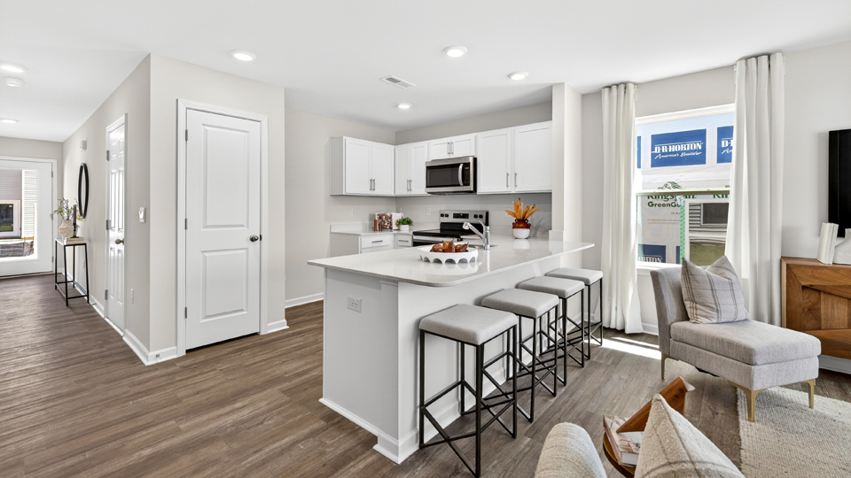 kitchen with quartz counters, kitchen peninsula, pantry, stainless steel appliances
