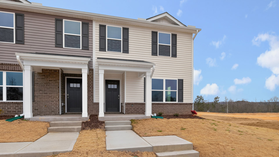 Two story town home with yellow siding.