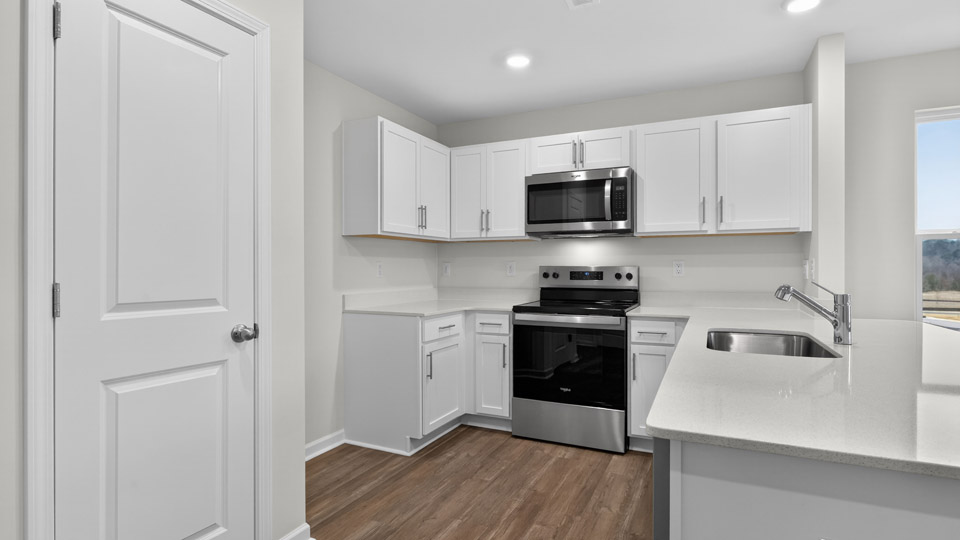 Kitchen with white cabinets and stainless steel appliances.
