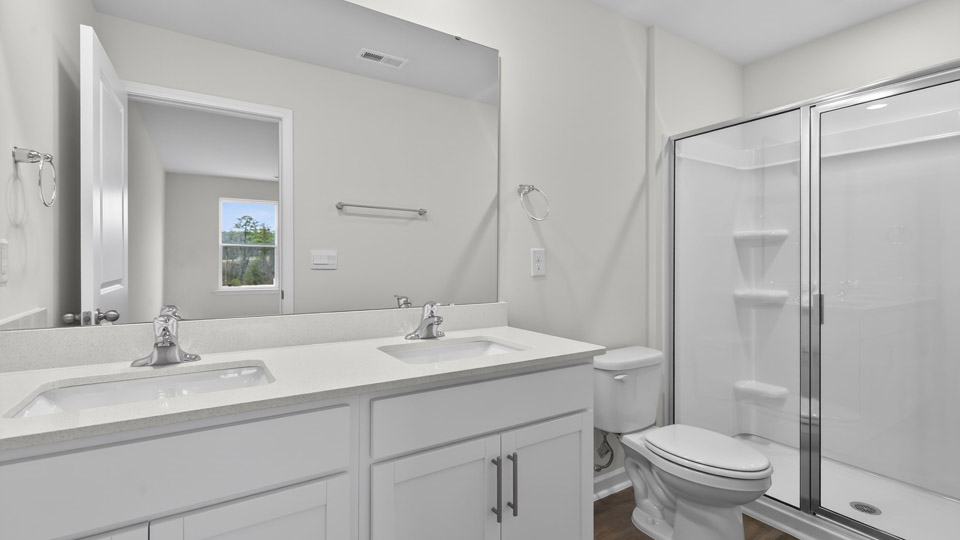 Primary bathroom with double sink and walk-in shower