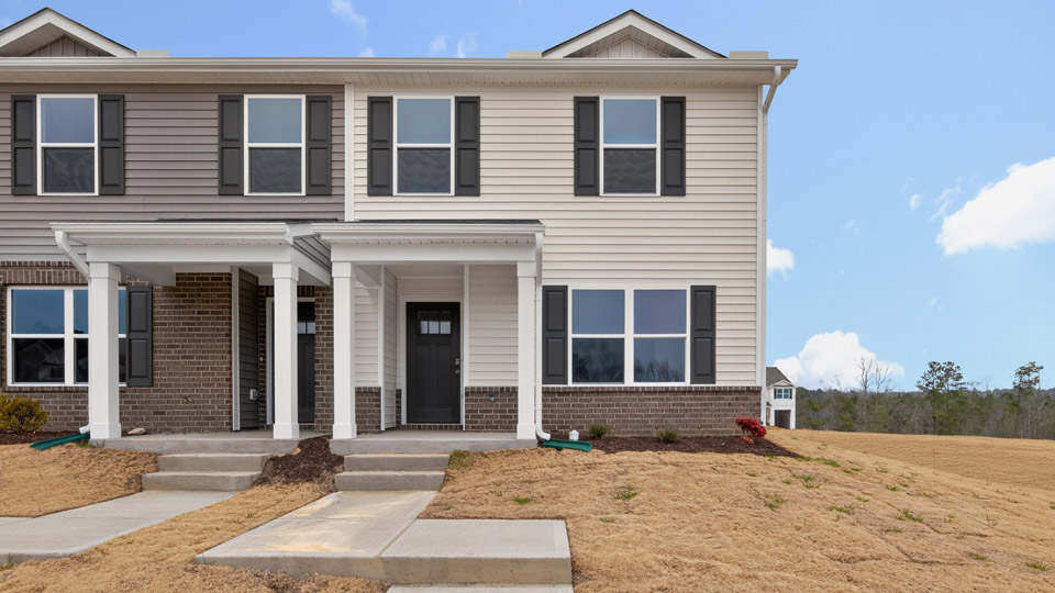 Two story town home with yellow siding.