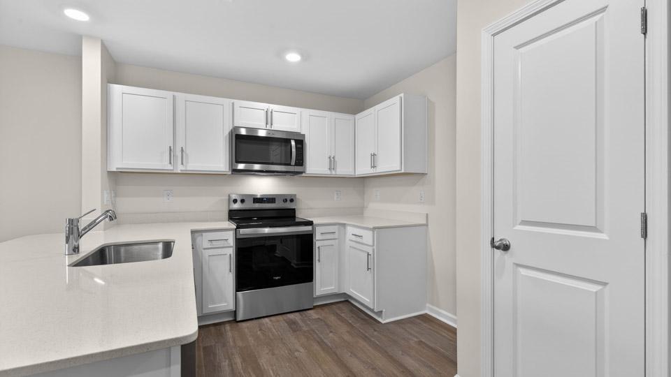 Kitchen with white cabinets and stainless steel appliances.