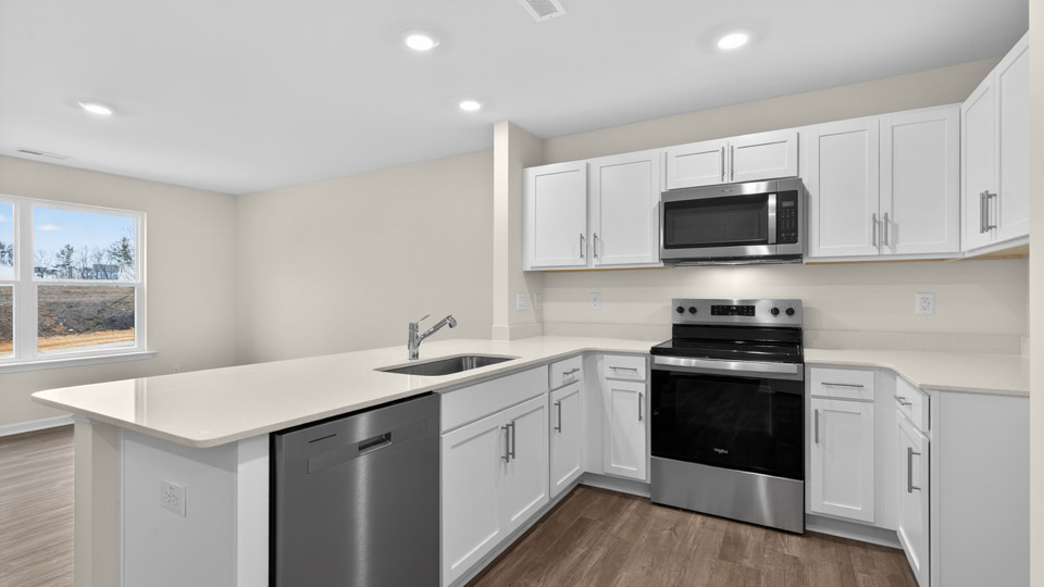 Kitchen with white cabinets and stainless steel appliances.